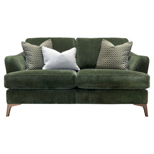 A green 2 seater sofa with patterned accent pillows, featuring a sleek design with wood legs.