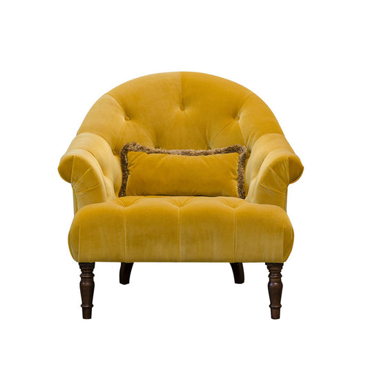 An Image of Alexander & James Imogen Button Chair. The chair is in a bright yellow velvet fabric with dark brown wooden legs. The chair is a cut out on a white background. 