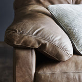 An close up image of the brown leather arm of the Bailey 2 Seater Sofa. 