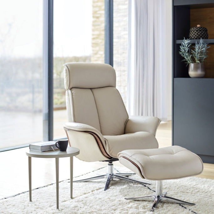 Beige recliner chair with ottoman in a modern living room setting