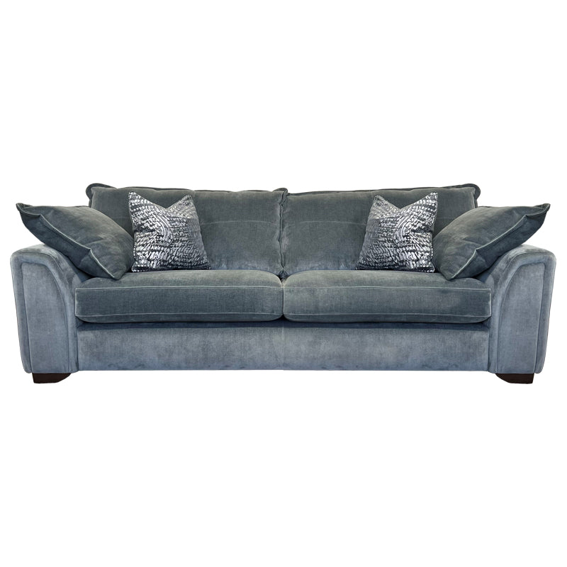 A blue three-seater sofa with two accent pillows, shown with a wooden footrest.