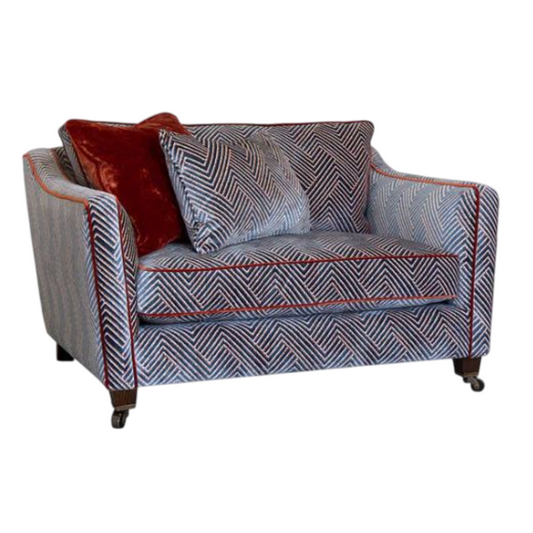 Patterned sofa with red and gray cushions on a white background