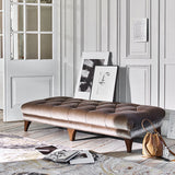 A lifetsyle image of the Luisa Footstool. The image shows the footstool in a velvet fabric finish. The footstool has picture image art on propped on top.
