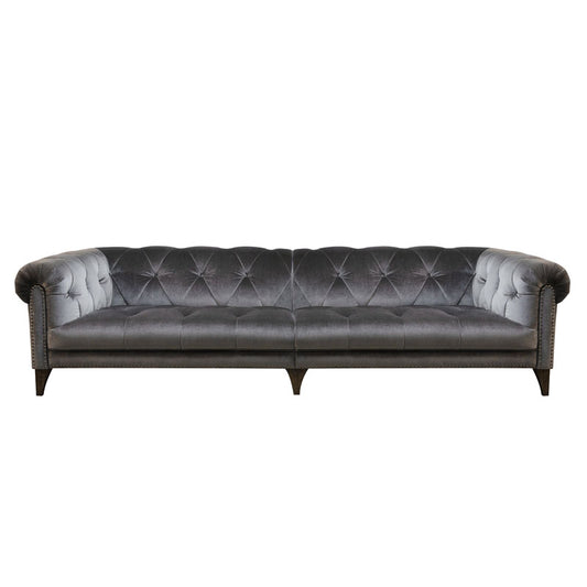 An image of the Alexander & James Luisa Shallow Seat sofa. The image is a cut out image on a white background. The image show the  Luisa in a grey velvet fabric. 