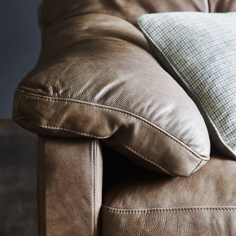 An close up image of the brown leather arm of the Bailey 2 Seater Sofa. 